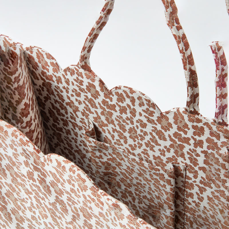 Turn heads with the Mrs. Alice Tote Bag in Leopard, a fashion-forward accessory that brings out your inner fashionista and embraces the captivating design of animal print.