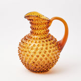 Transform your tabletop into a visual delight with the Amber Hobnail Jug, showcasing classic hobnail detailing.
