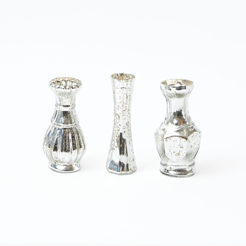 Impress your guests with the delightful charm of the Trio of Mercury Bud Vases, a collection that adds a touch of sophistication and a vintage aesthetic to any floral display.