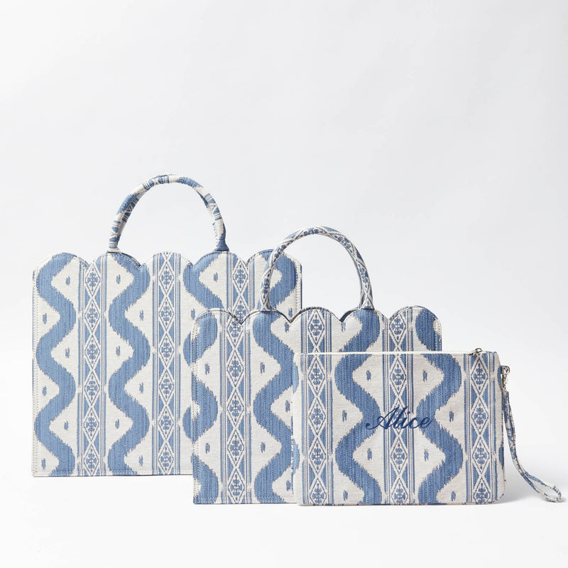 Create a fashion statement that stands out with the Blue Ikat Pochette, designed to bring an on-trend design and the vibrant appeal of Ikat patterns to your attire.