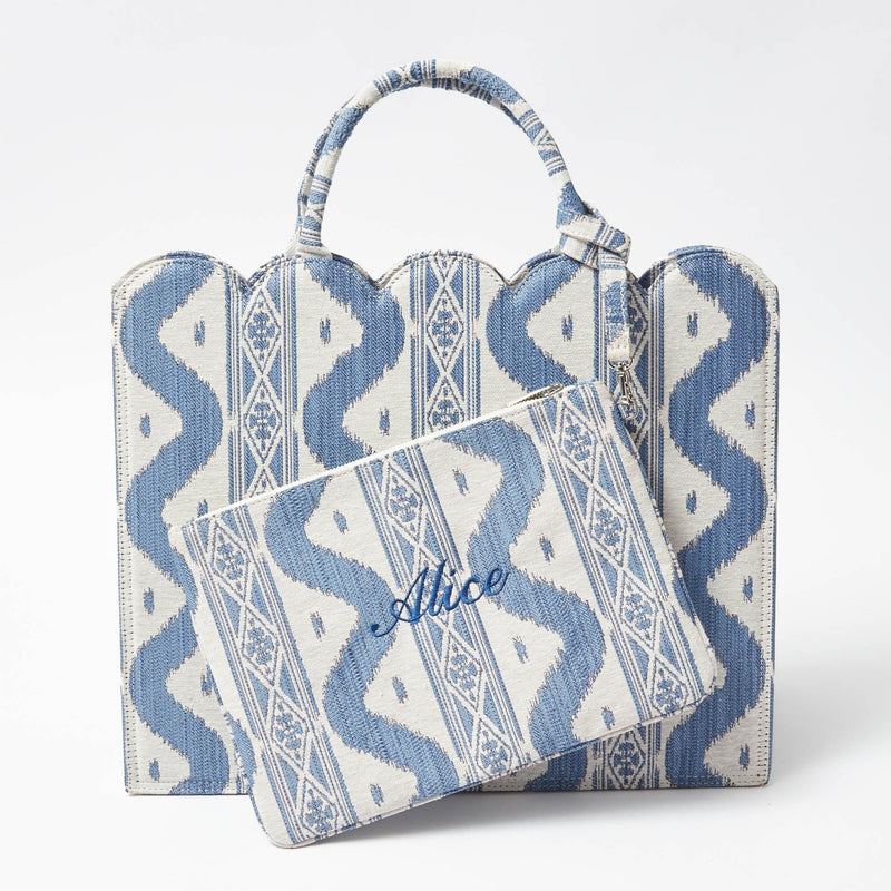 Elevate your accessory game with the Blue Ikat Pochette, a stylish piece that infuses your ensemble with a touch of exotic elegance and vibrant blue hues.