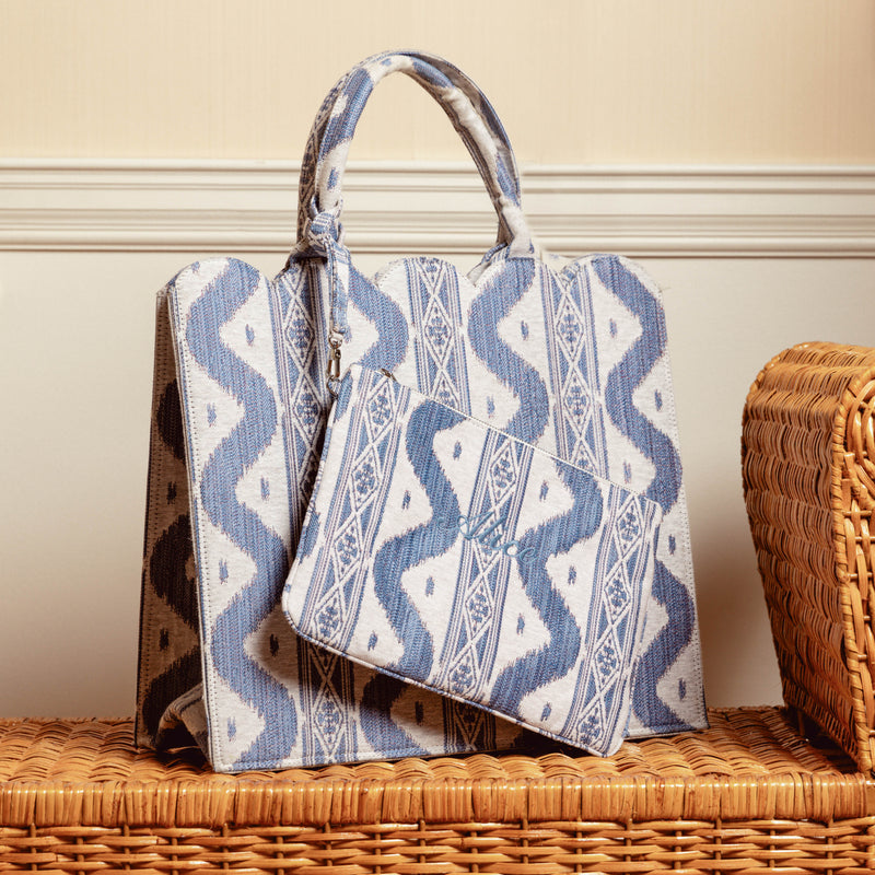 Adorn your ensemble with the captivating charm of Ikat-inspired patterns, courtesy of the Blue Ikat Pochette, an accessory that transforms your look into a stylish and trendy ensemble.