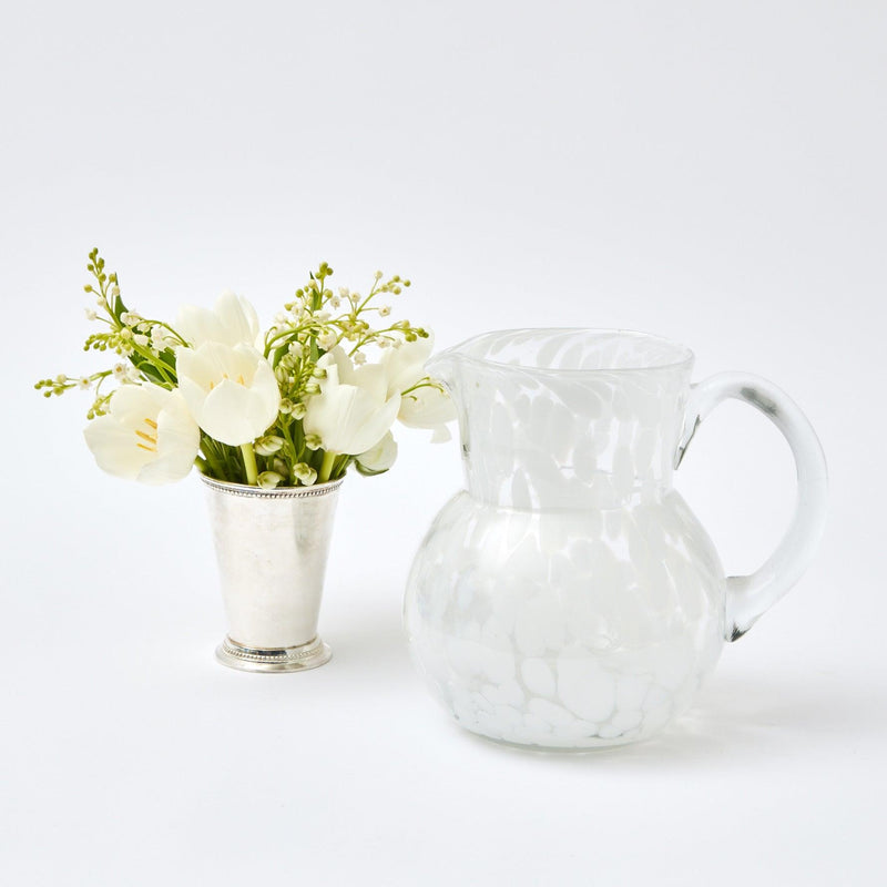 Elevate your Christmas gatherings with the festive beauty of our Dappled White Glasses & Jug Set - a symbol of holiday grace, offering both glasses and a jug for a complete table setting.