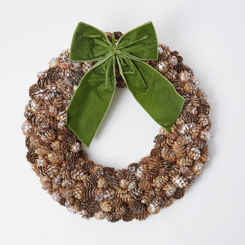 Enhance your home with the rustic beauty of our Frosted Pinecone Wreath, adding a touch of winter tradition to any room.