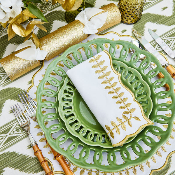 Elevate your dining experience with the White & Gold Laurel Placemats & Napkins - a set of four that adds a touch of timeless beauty and sophistication to your table decor.