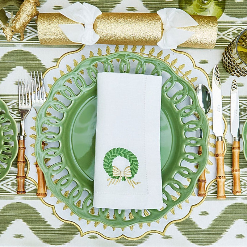 The intricate wreath embroidery on these napkins exudes classic holiday charm.