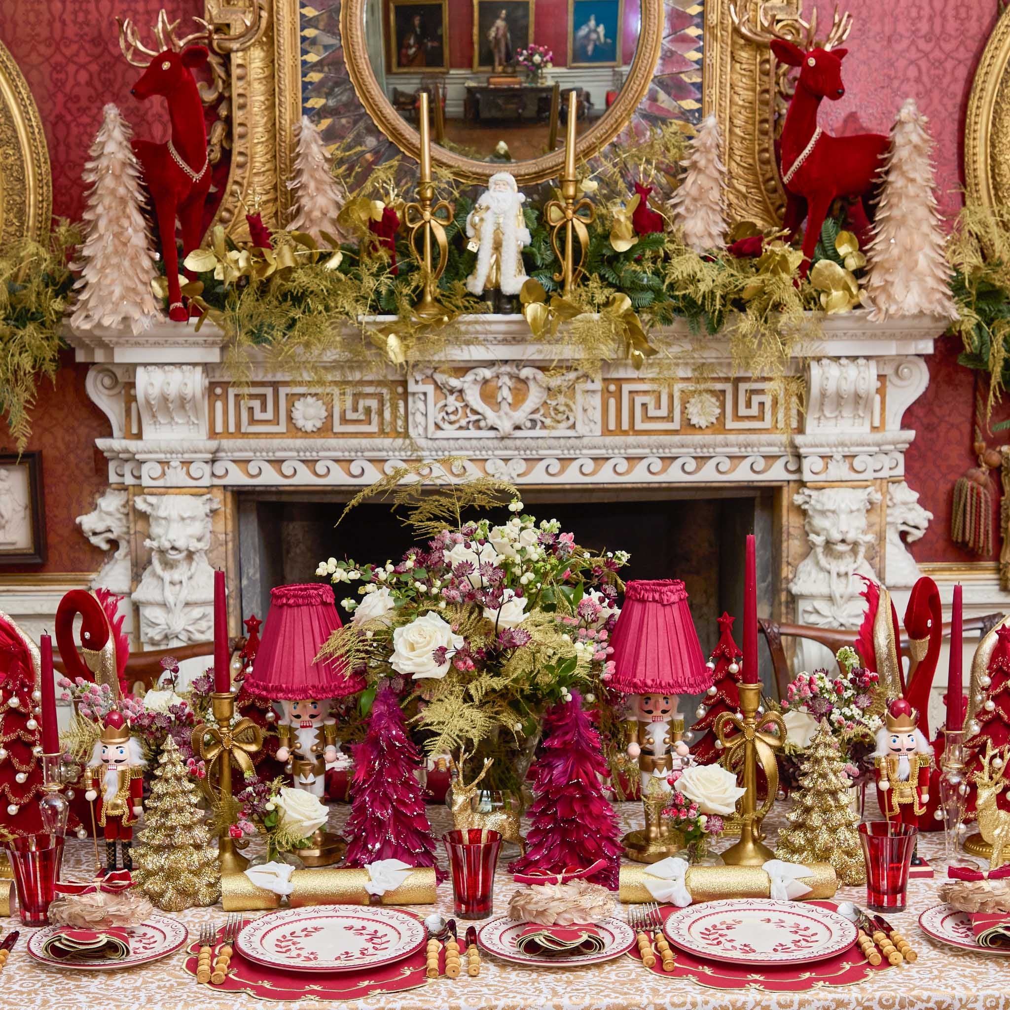 Decorative Christmas table setting with red and gold elements in a festive room.
