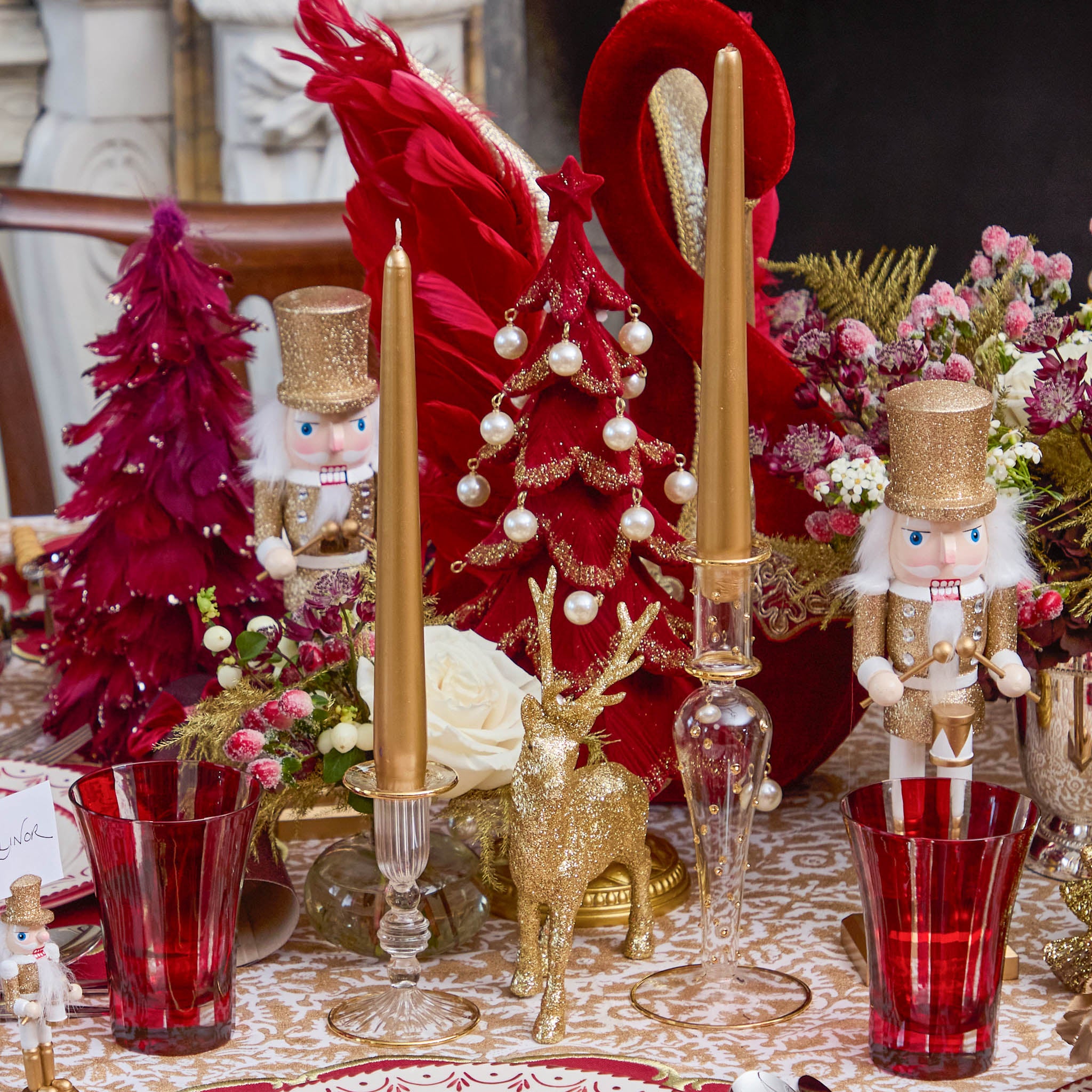 Decorative Christmas table setting with red and gold elements.
