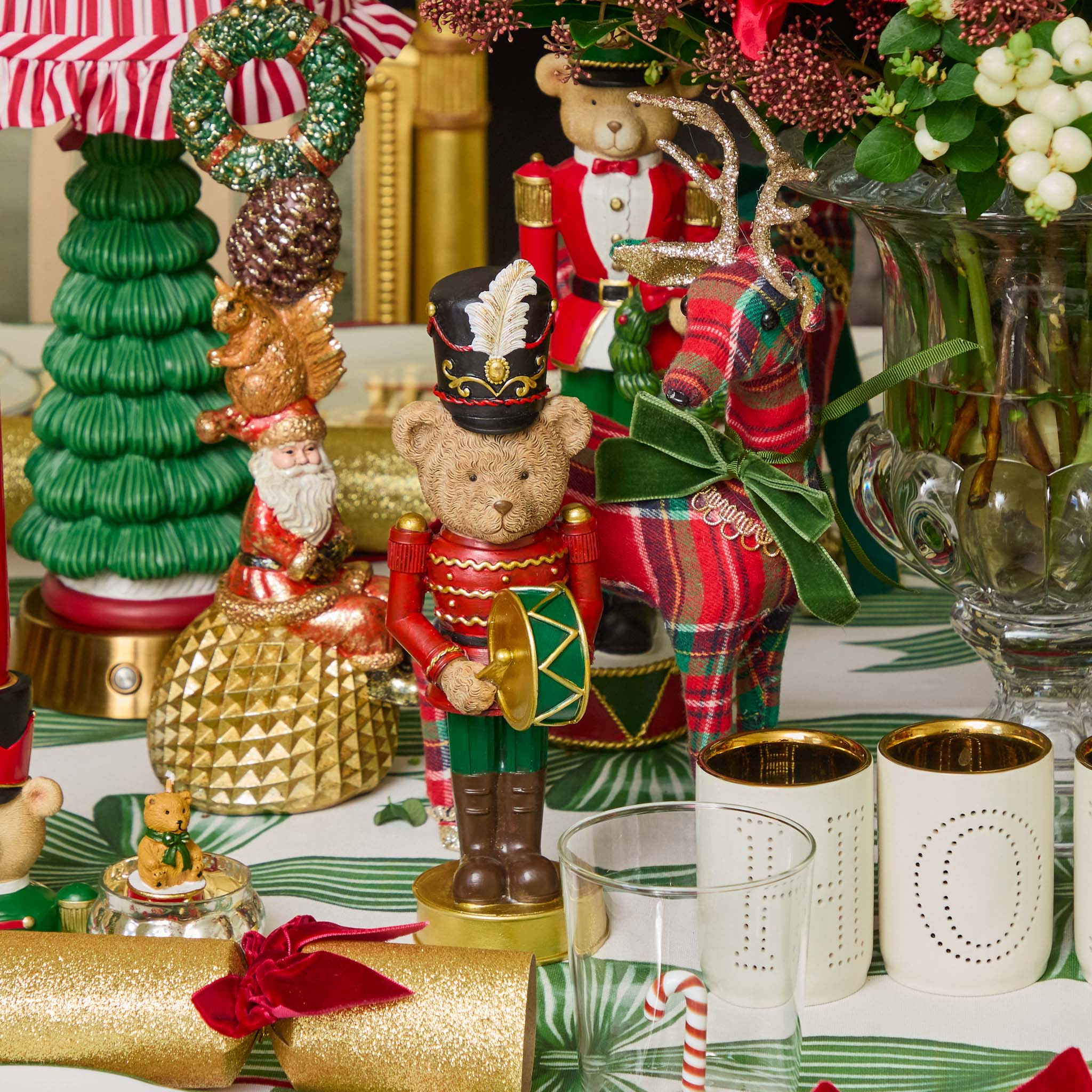 Decorative Christmas table setting with teddy bears, Nutcrackers, and festive decorations.