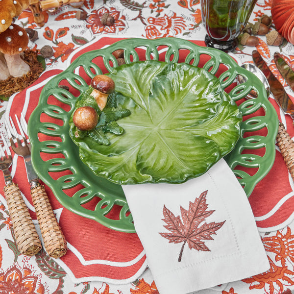 Collection of four plates featuring intricate porcini mushroom and cabbage designs.