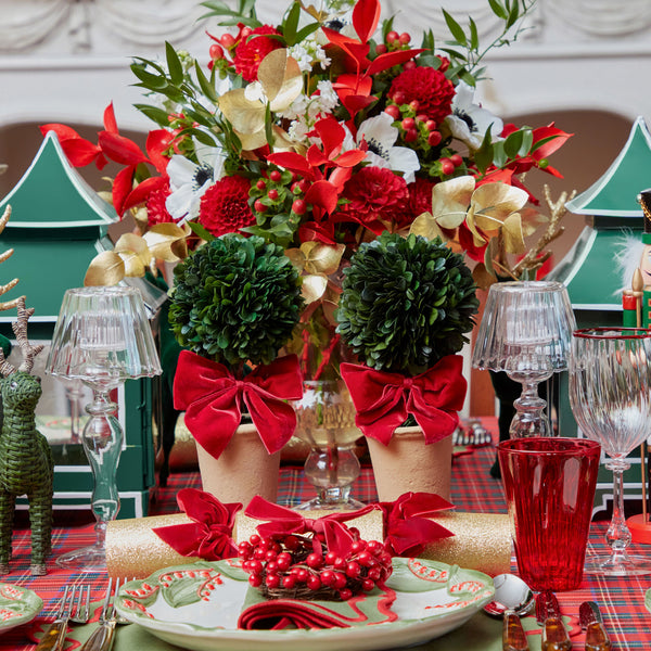 Create a festive and inviting Christmas atmosphere with the Red Ribboned Potted Boxwood Balls, perfect for infusing your space with holiday charm.