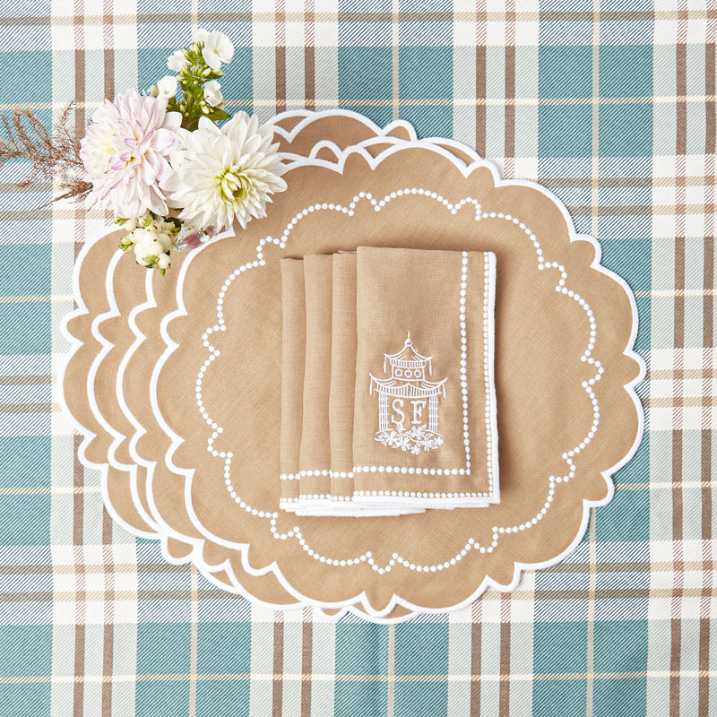 Coordinated set of 4 placemats and napkins in tasteful Mariana Sand hues.