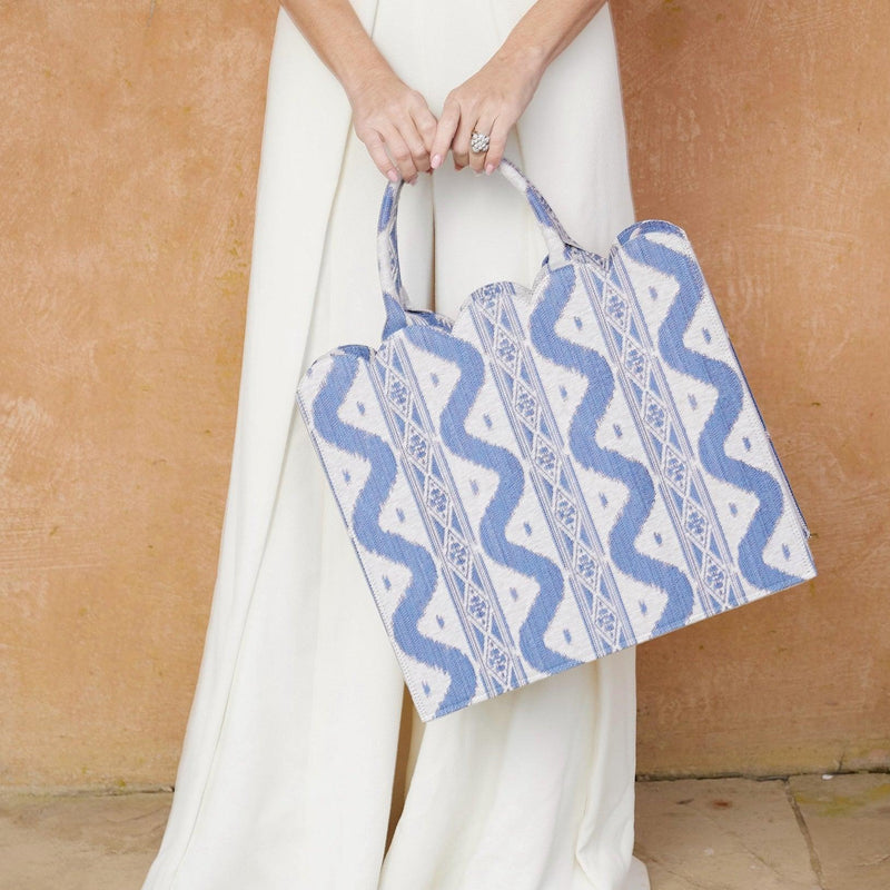 Celebrate the allure of traditional patterns with the Mrs. Alice Tote Bag in Blue Ikat, a must-have for infusing your style with the warmth and charm of classic design.