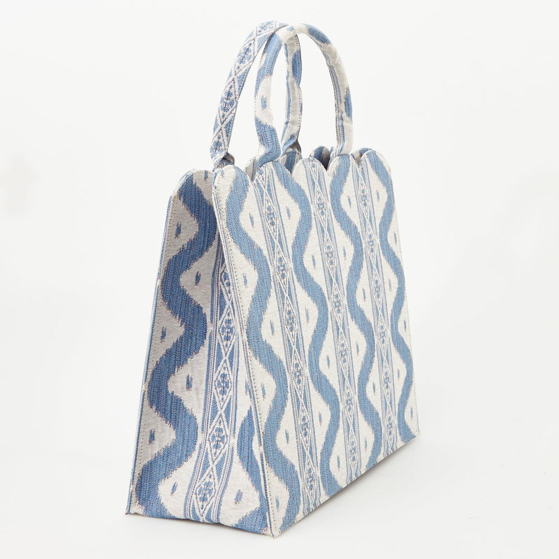 Add a touch of classic charm to your outfits with the Mrs. Alice Tote Bag in Blue Ikat, perfect for creating a coordinated and elegant look.