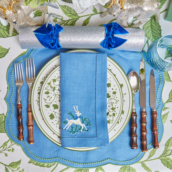Elevate your table decor with Eloise Blue & Green Placemats & Prancing Deer Napkins Set, a harmonious combination of style and grace.