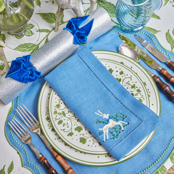 Elevate your table decor with these charming blue linen napkins adorned with prancing deer.
