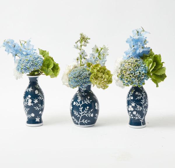 Elevate your floral arrangements with the Midnight Blue Hand Painted Tole Bud Vases (Set of 3). Their exquisite design adds a touch of sophistication to any space.