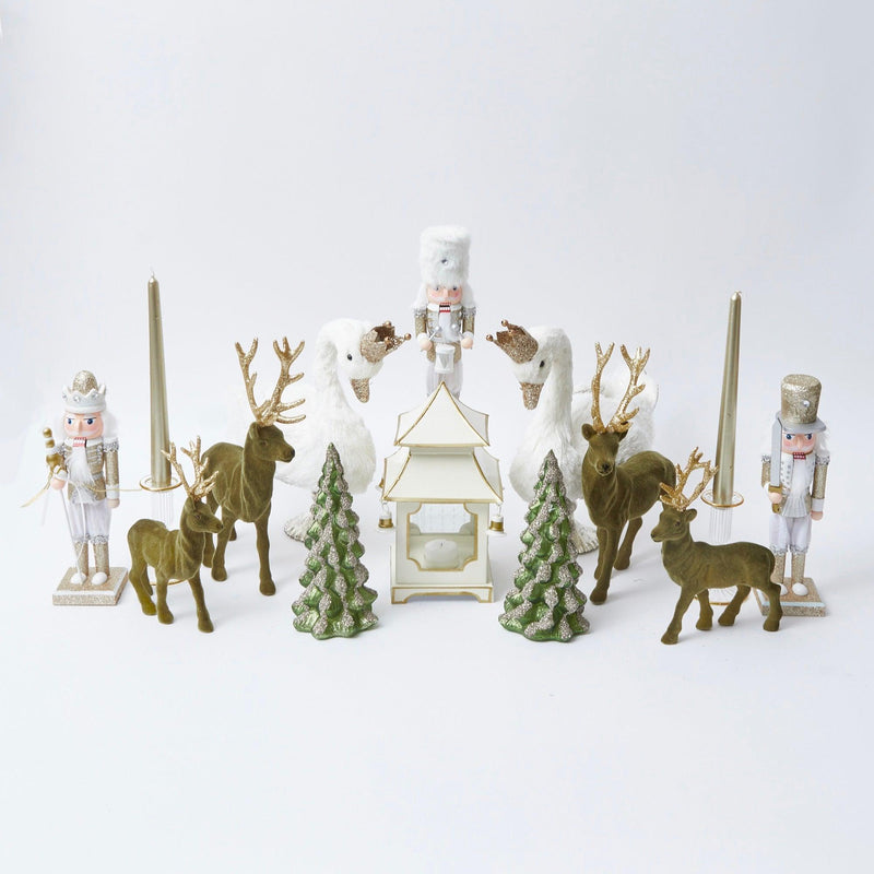 Elevate your Christmas decor with the whimsical and enchanting Olive Green Flocked Reindeer Family - a simple yet stylish statement of holiday delight with a woodland twist.