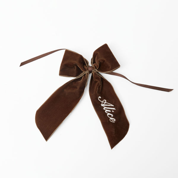 Customizable chocolate-hued napkin bow for personalization.