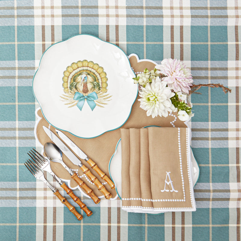 Four-piece set of placemats and napkins showcasing the graceful Mariana Sand palette.