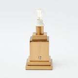Stand for a rechargeable table lamp, offering versatile placement.