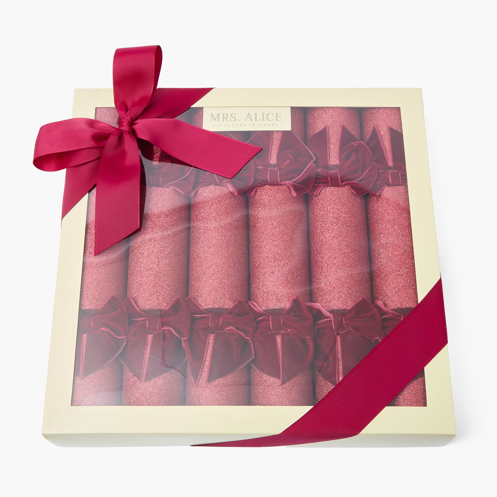 Set of pink crackers in a decorative box with a red ribbon on a white background