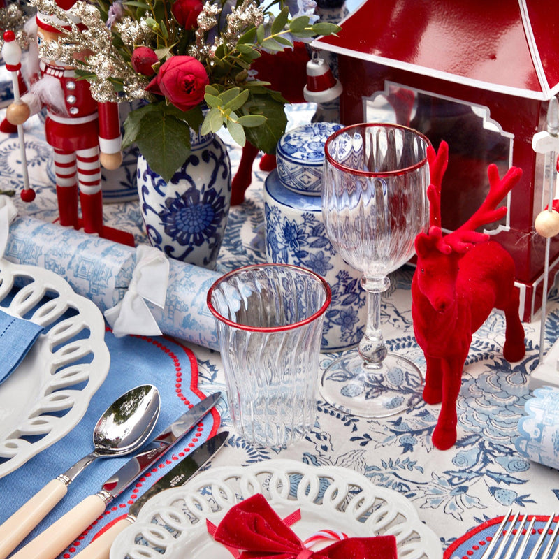 Turn your Christmas celebrations into a cheerful affair with the Red Rim Glassware Set, featuring a combination of water and wine glasses for a complete holiday table setting.