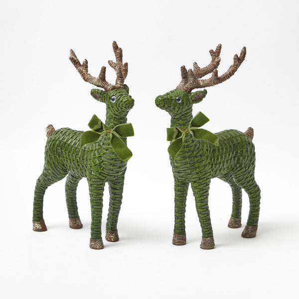Add a touch of woodland enchantment to your holiday decor with the Forest Green Rattan Reindeer Pair, complete with elegant green velvet bows, a delightful addition to your festive display.