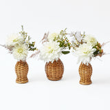 Set of 3 mini rattan vases, perfect for petite floral arrangements.