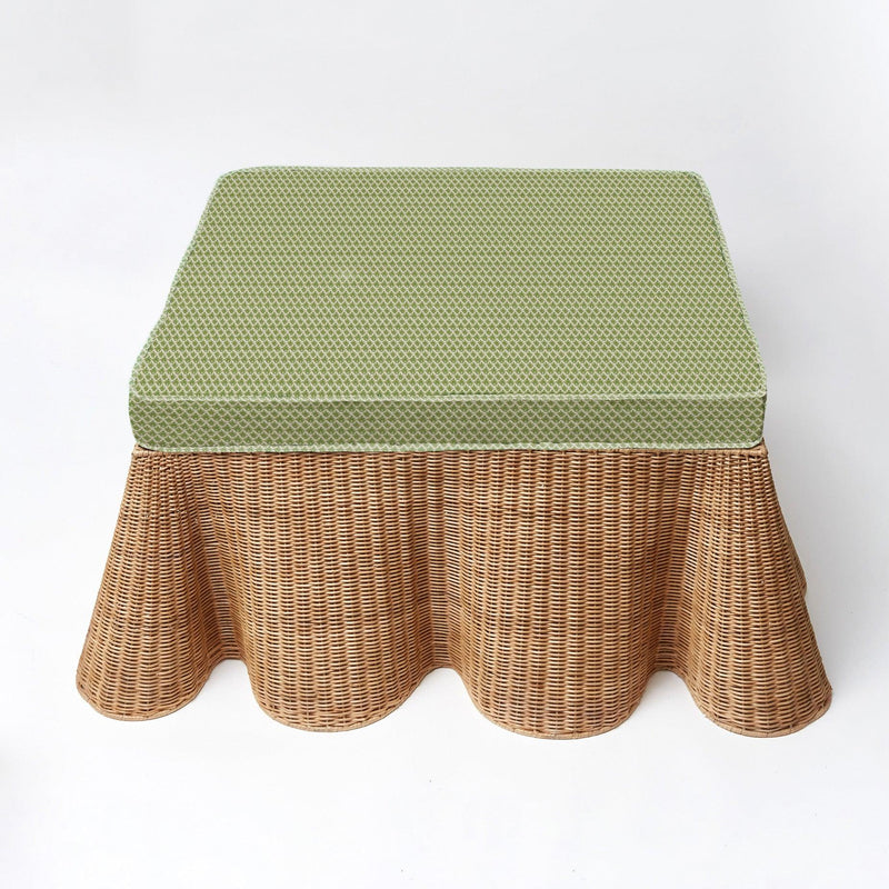Transform your living space with the Vivienne Rattan Scalloped Ottoman, a stunning and versatile piece that adds a touch of sophistication, additional seating, and style to your home.
