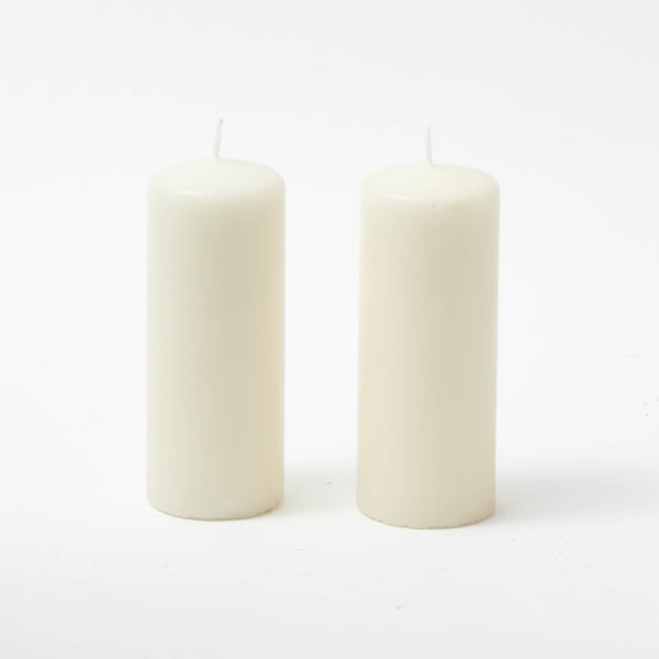 Illuminate your space with the timeless elegance of the White Pillar Candle Pair, a duo that adds a touch of classic charm to any occasion.