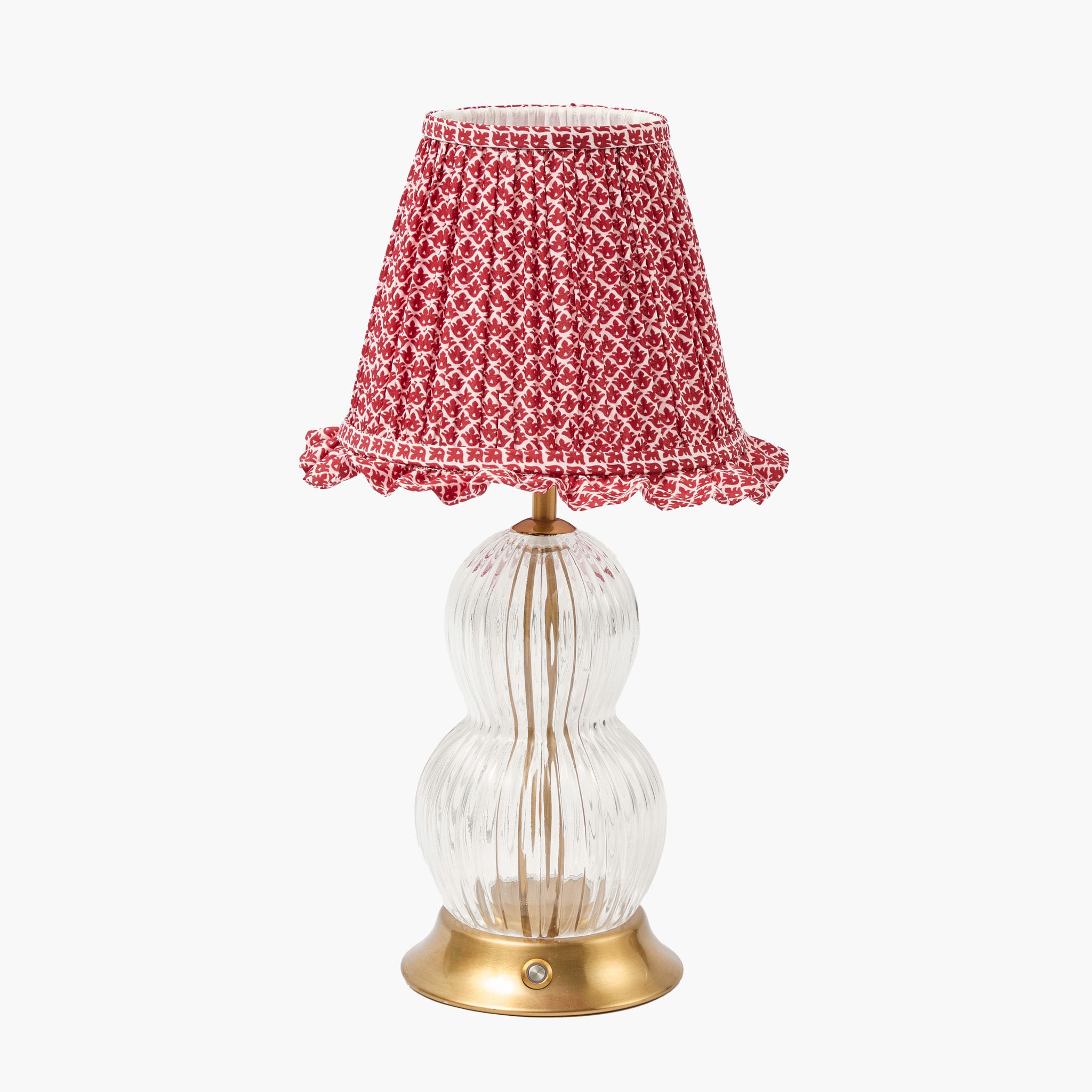 Table lamp with a red patterned shade on a white background