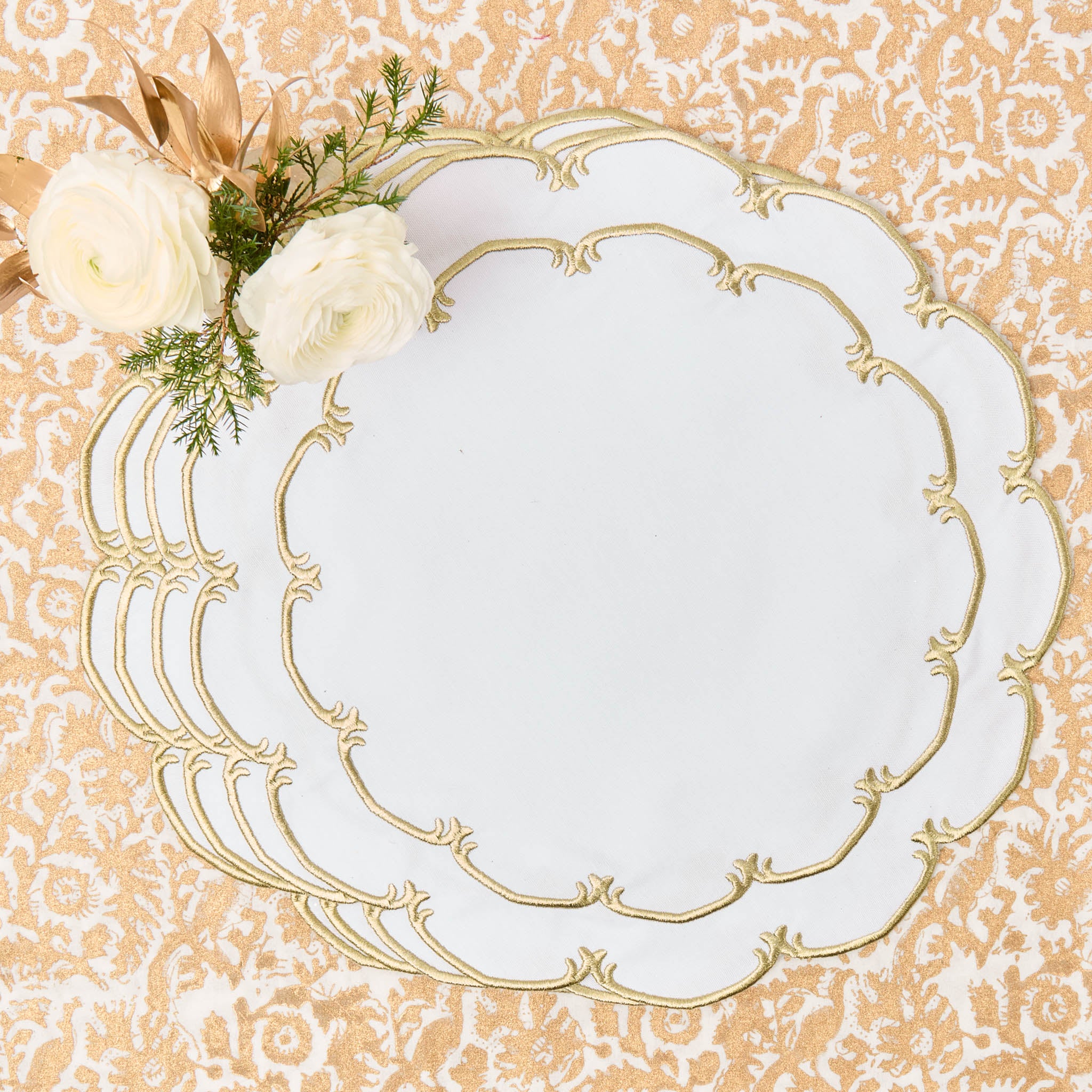 Decorative white plate with gold rim on a patterned background