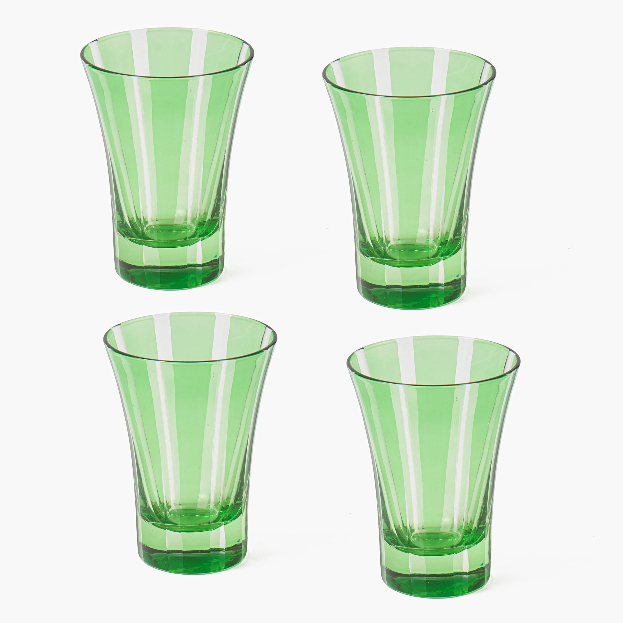 Four green glass tumblers with striped design on a white background