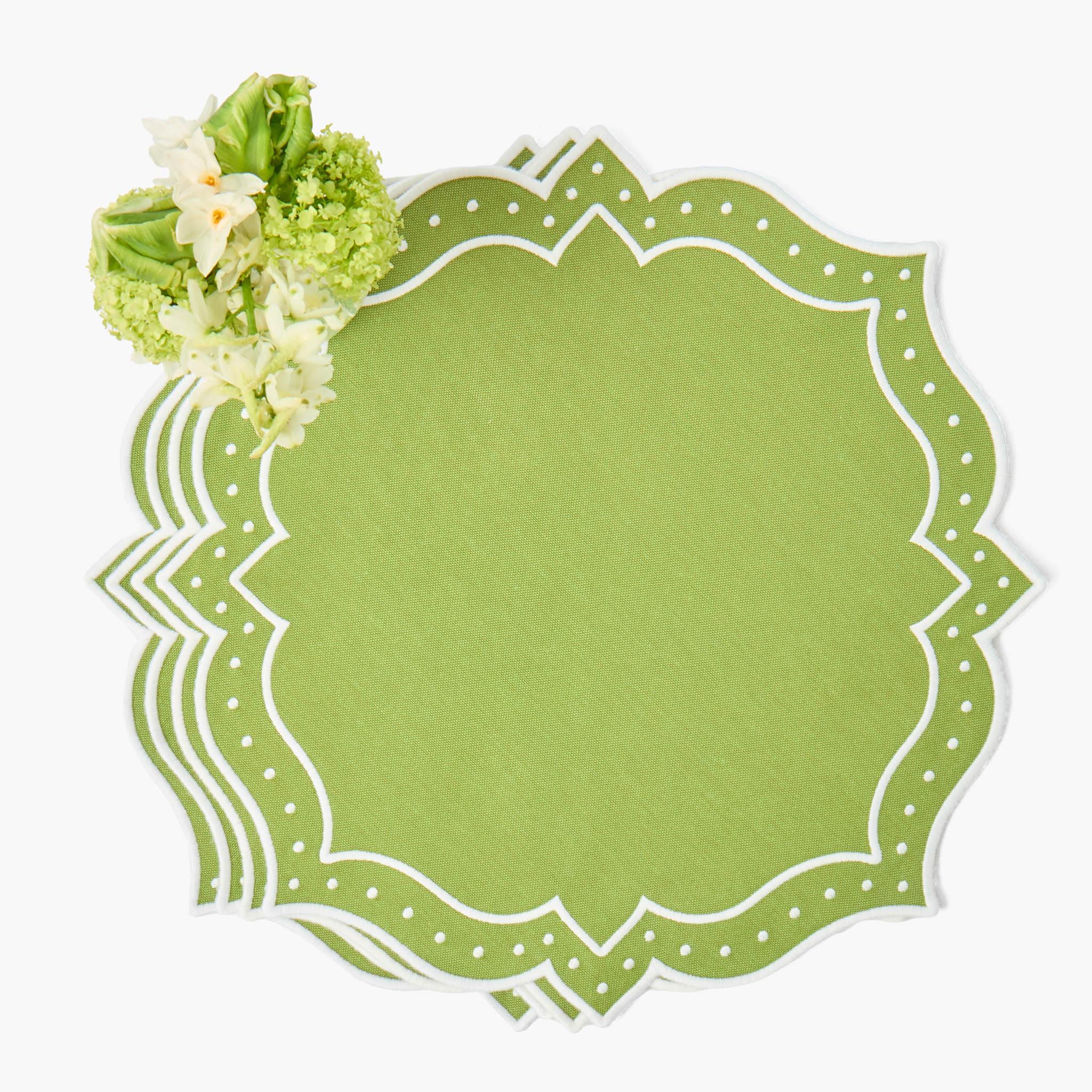 Decorative green paper with floral elements on a white background