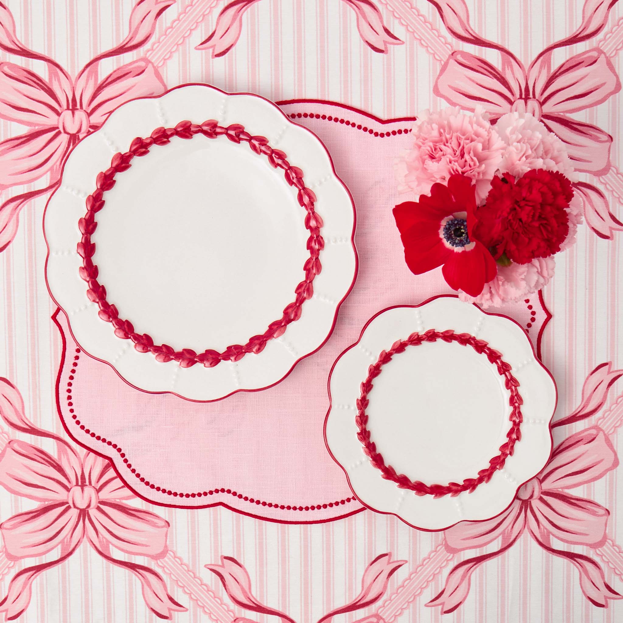 Decorative plates with floral design on a pink patterned background
