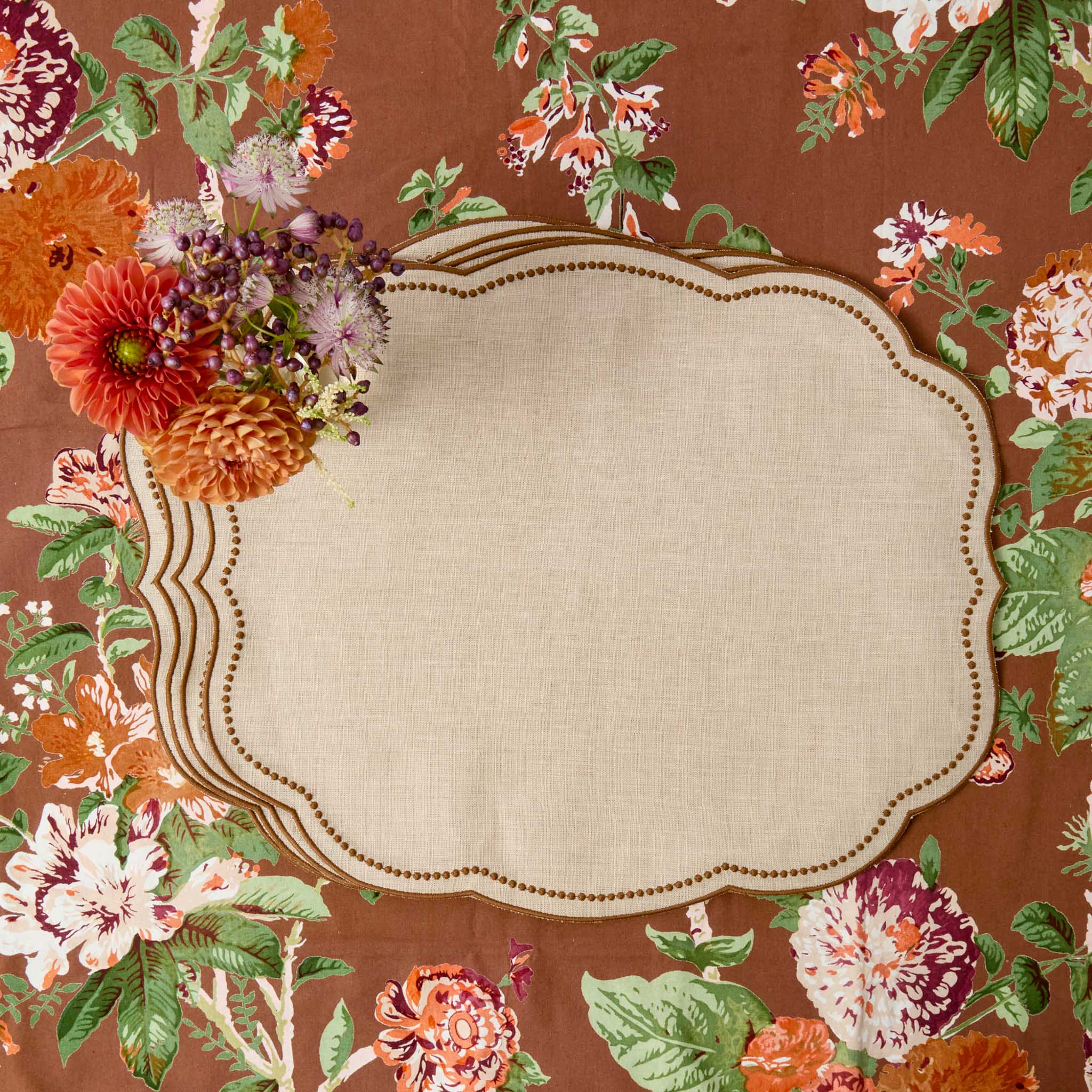 A decorative Eloise Taupe & Chocolate Linen Placemat on a brown Aurelia Tablecloth.