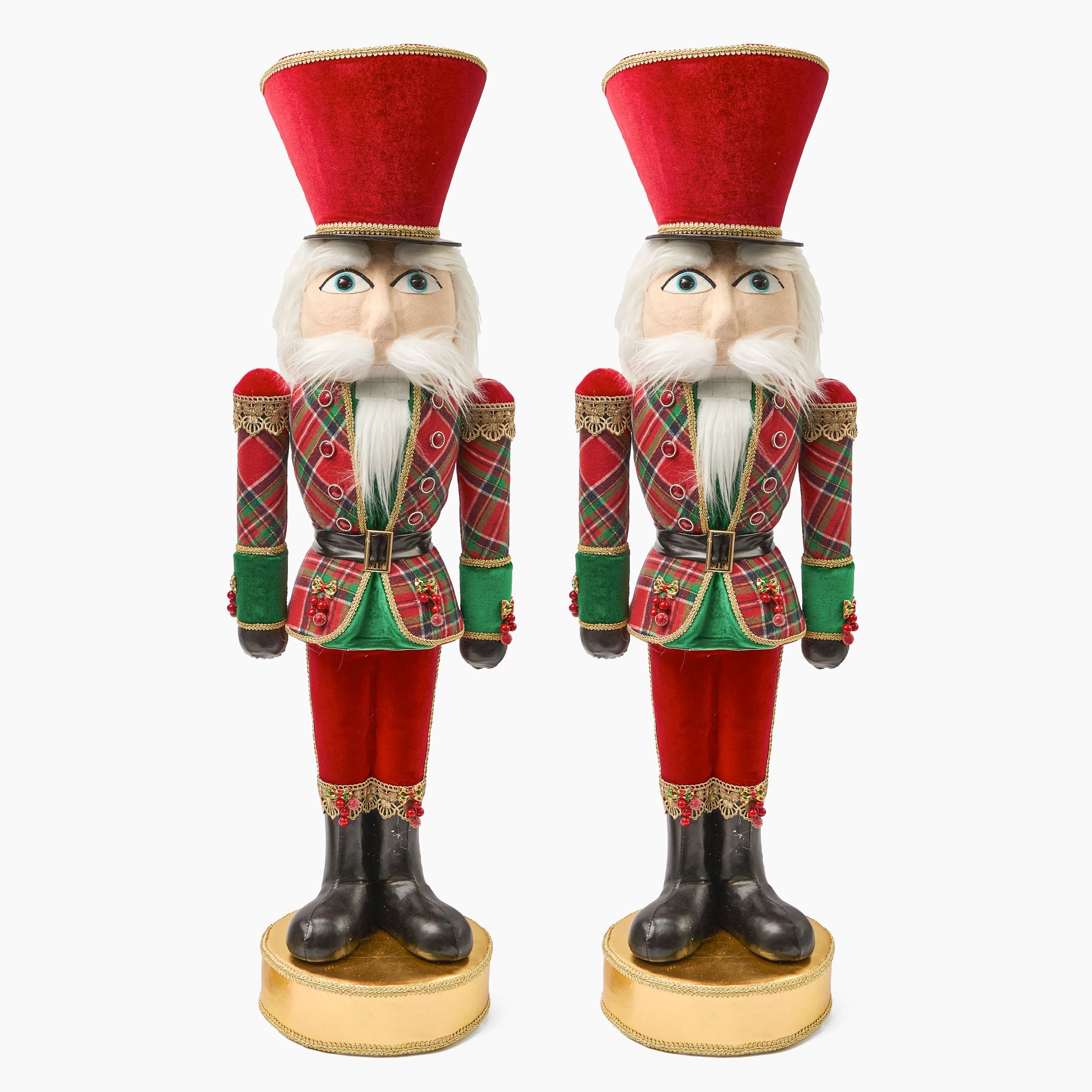 Two Christmas nutcrackers in red and green plaid uniforms on a white background