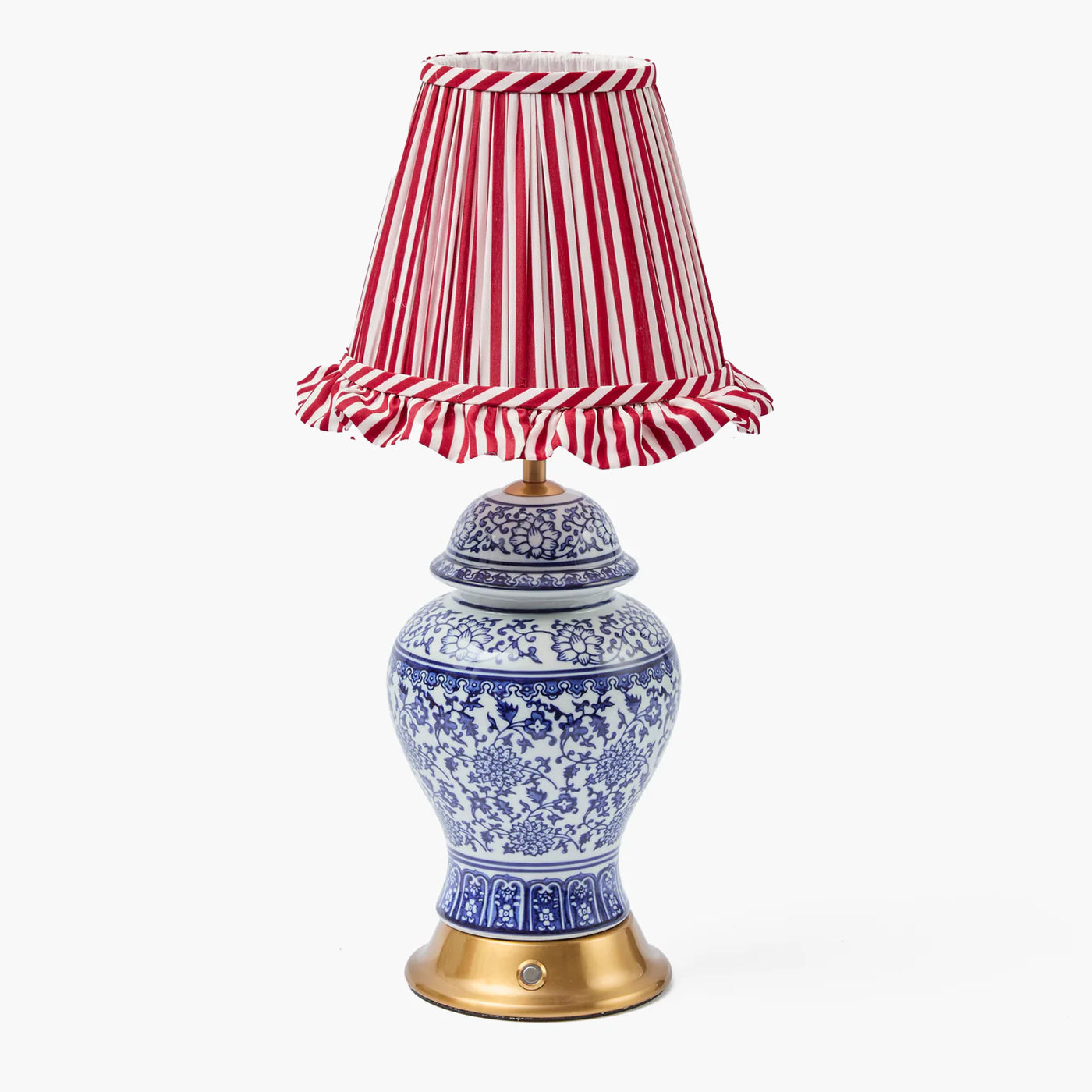 Decorative lamp with a blue and white patterned base and a red and white striped shade on a white background