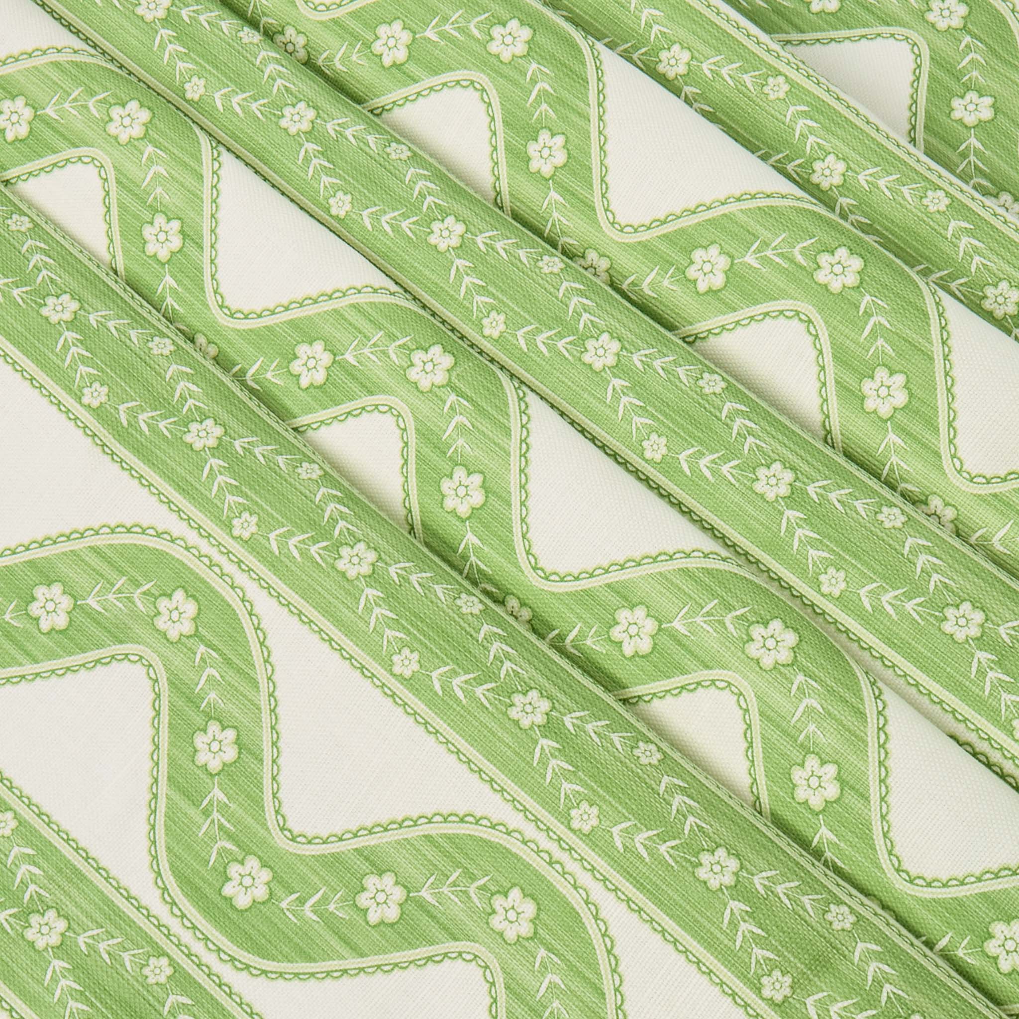 Green fabric with floral pattern on a white background