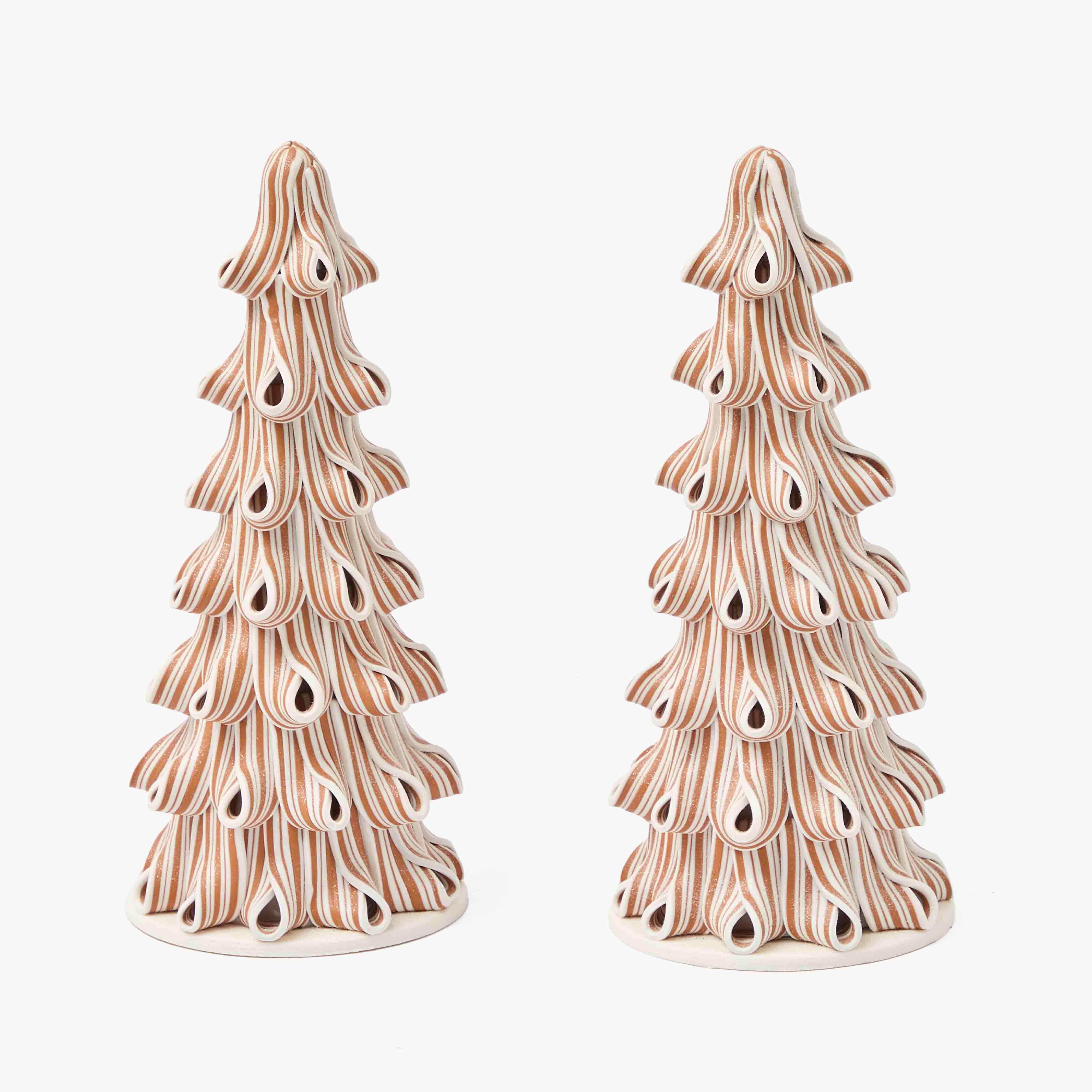 Two ceramic Christmas tree figurines on a white background
