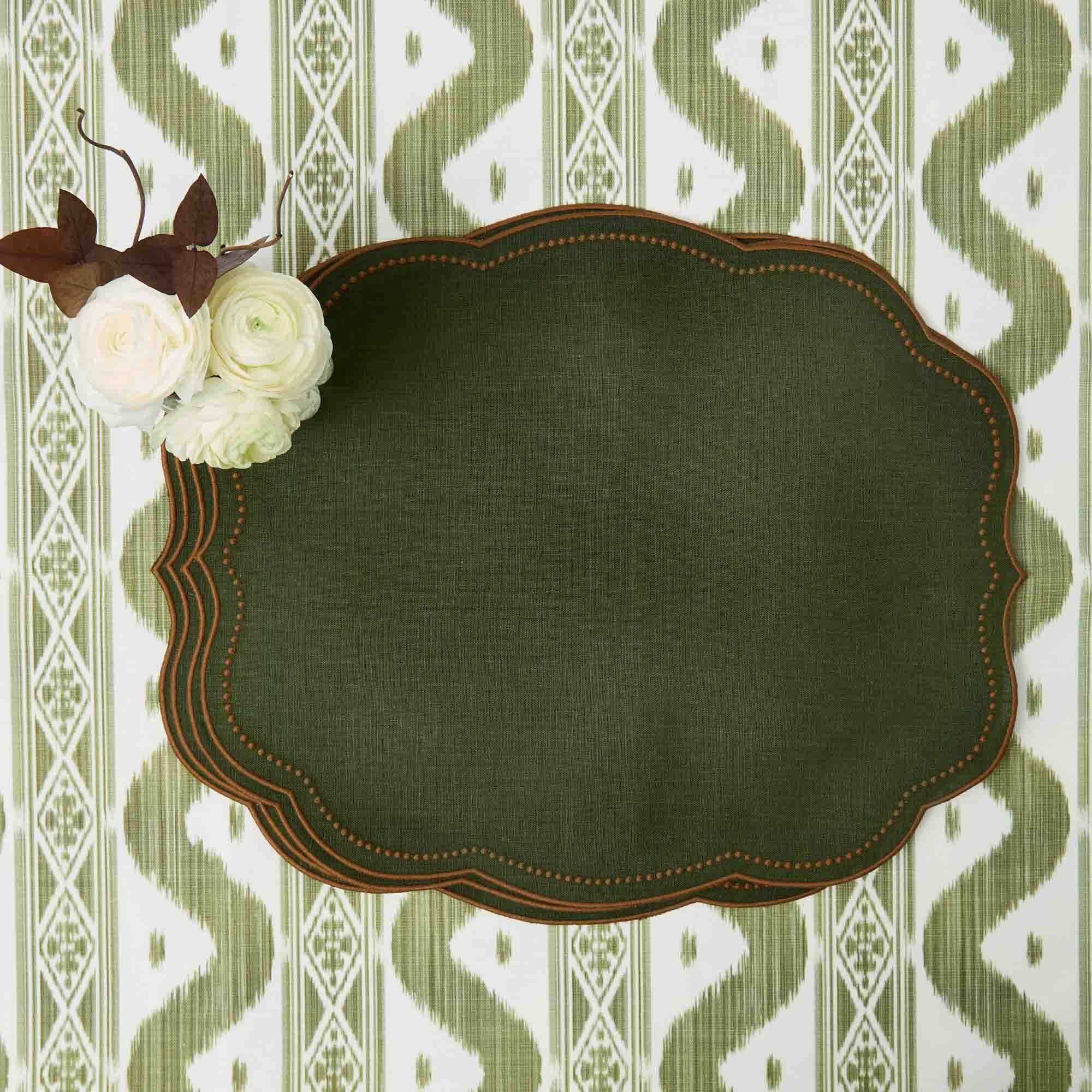 Decorative green plate with brown rim on a patterned background