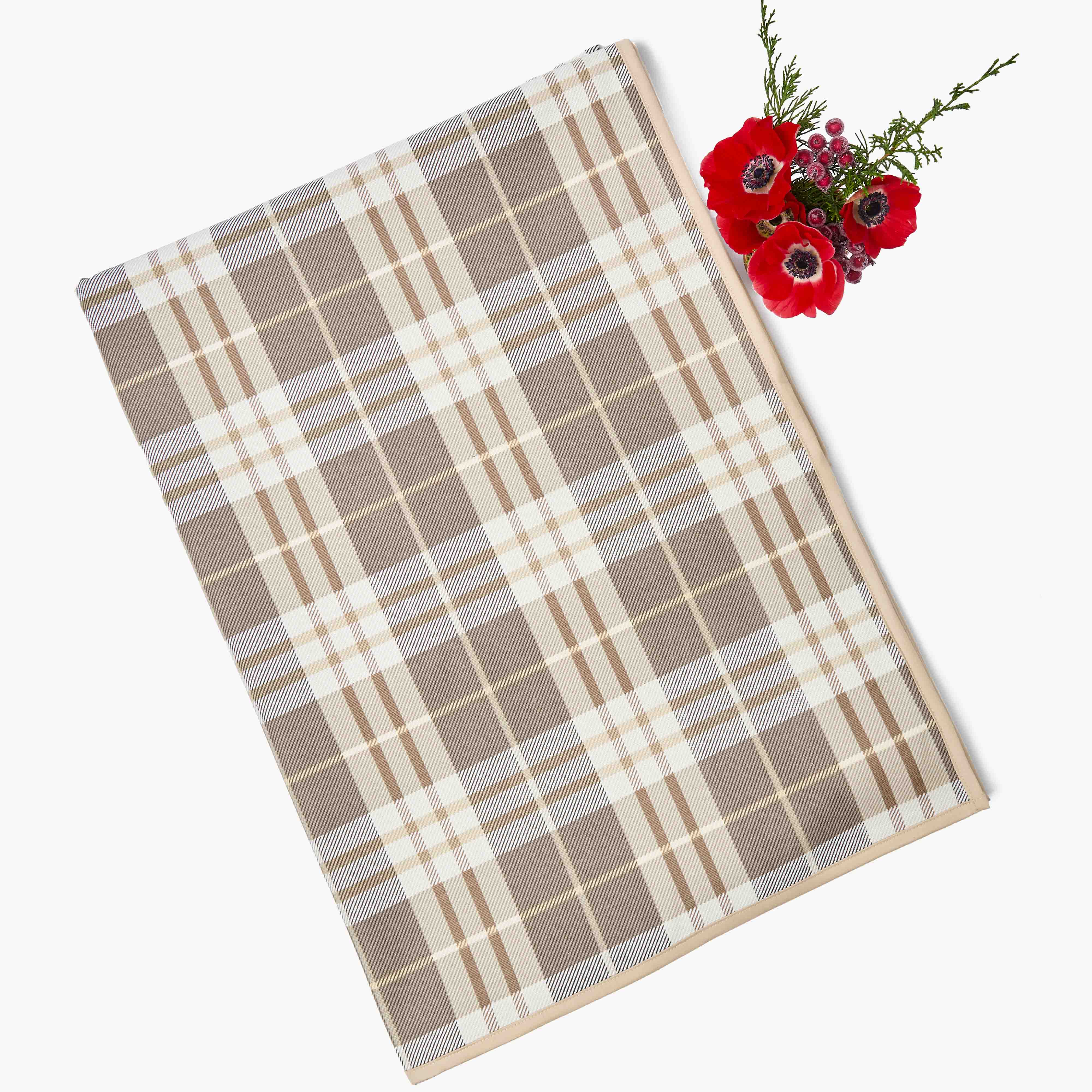 Plaid placemat with a bouquet of red flowers on a white background