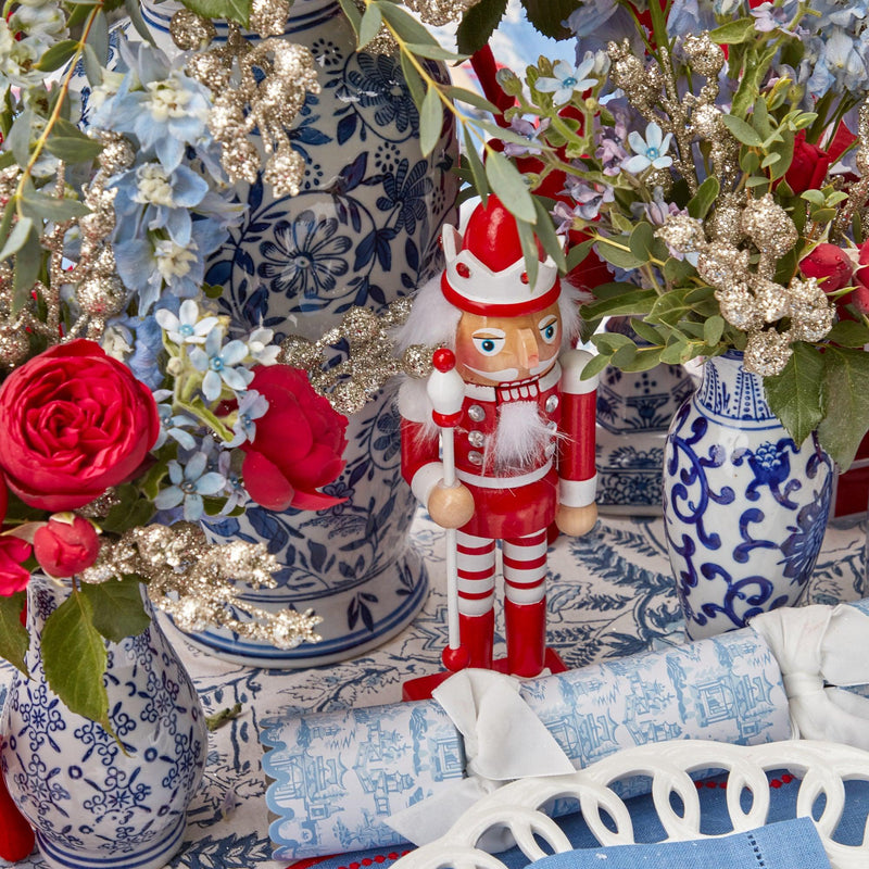 Illuminate your Christmas decor with the whimsical and enchanting beauty of the Candy Cane Nutcracker Pair, designed to bring the magic of the holiday season to your festive table.