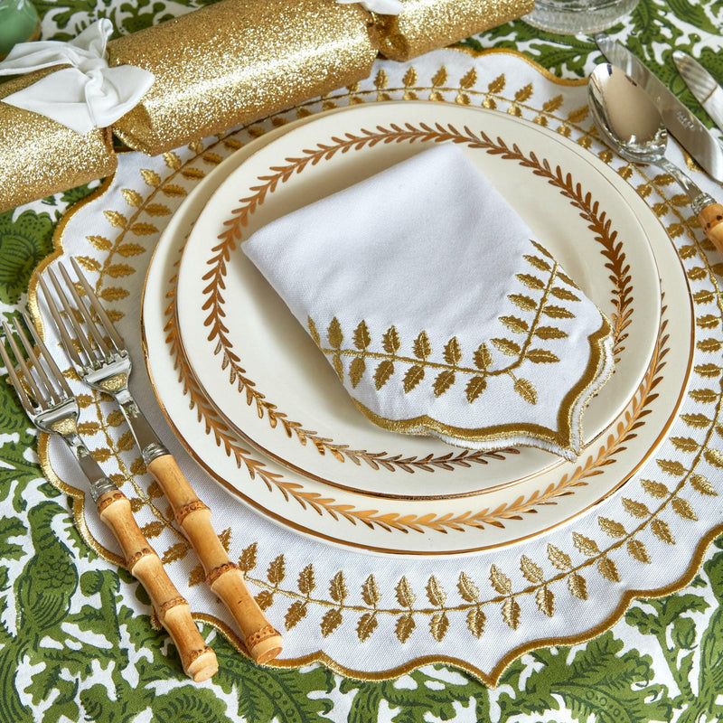 Enhance your dining experiences with the warm and welcoming presence of the White & Gold Laurel Placemats & Napkins, designed to bring a touch of tradition and sophistication to your table settings.