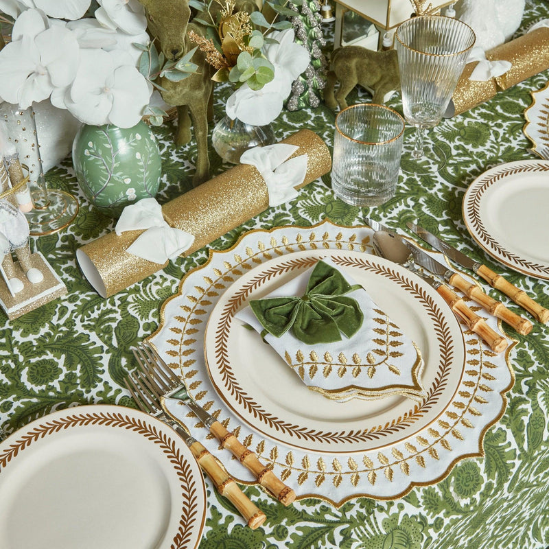 Elevate your dining experience with the White & Gold Laurel Placemats & Napkins - a set of four that adds a touch of classic beauty and sophistication to your table decor, creating an unforgettable setting for your meals.