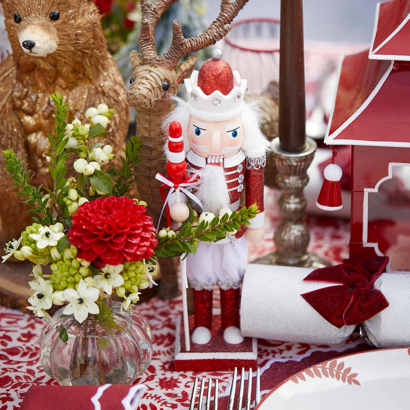 Add a touch of holiday whimsy to your celebrations with the Red Glitter Nutcracker Trio, designed for those who appreciate the beauty of tradition.